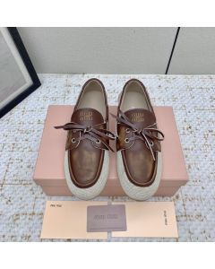 MIU MIU Canvas and bleached leather boat shoes